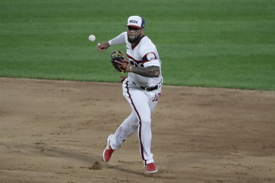 Chicago White Sox third baseman Yoan Moncada can't make the play on a single by Cleveland Indians' Carlos Santana during the 10th inning of a baseball game in Chicago, Sunday, Aug. 9, 2020. (AP Photo/Nam Y. Huh)