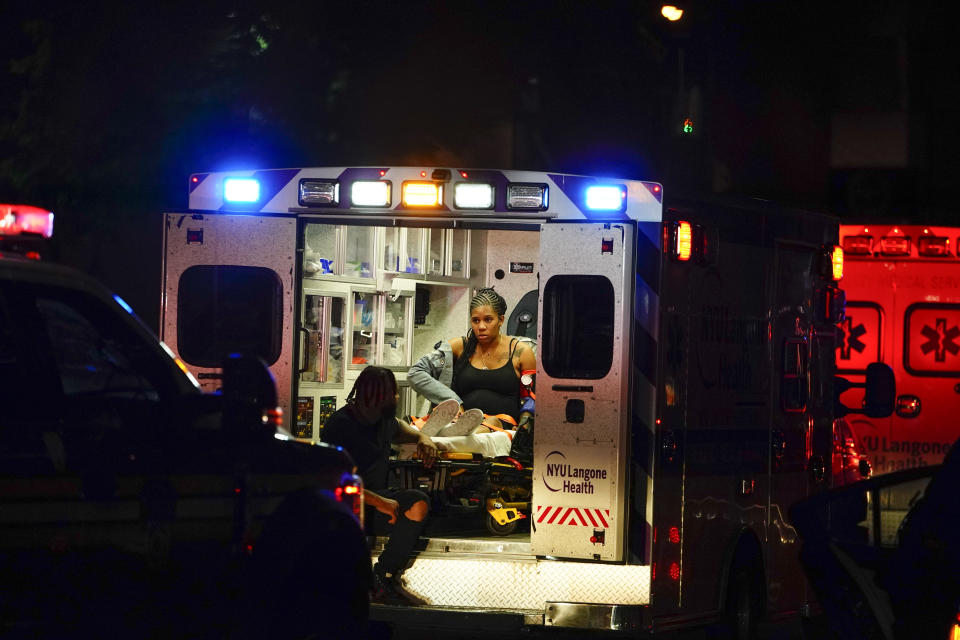 A woman is placed inside an ambulance outside of Barclays Center after a WBA lightweight championship boxing bout Sunday, May 29, 2022, in New York. (AP Photo/Frank Franklin II)
