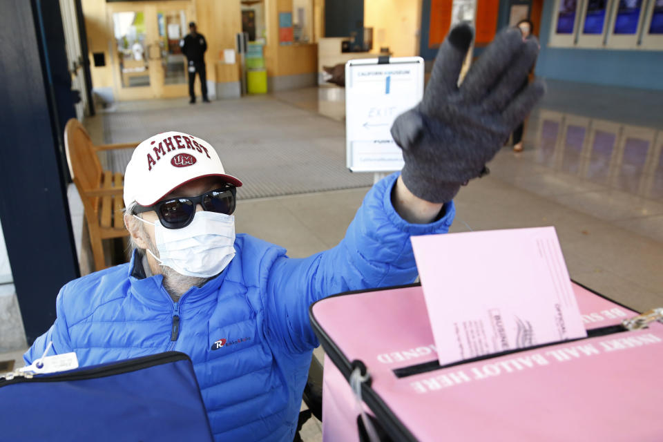 FILE - In this Monday, March 2, 2020 file photo, a man wearing a mask as a precaution against passing or receiving germs casts his ballot on the eve of Super Tuesday, at a voting center in Sacramento, Calif. On Friday, June 19, 2020, The Associated Press reported on stories circulating online incorrectly asserting all California registered to vote as an independent will not be able to vote Republican in 2020. Information contained in the post does not apply to the general election this fall. During California’s presidential primary election on March 3, independent voters, also known as “no party preference” voters, could vote in the Democratic presidential primary without changing their party affiliation, but not in the Republican primary. (AP Photo/Rich Pedroncelli)