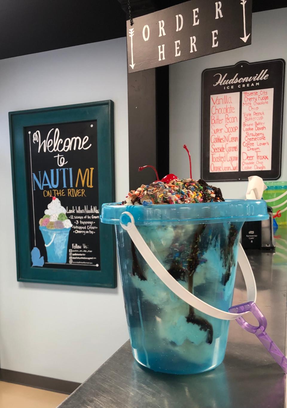 The "Look Who's Nauti Now" sundae at NautiMI on the River includes 12 scoops of ice cream, three toppings, whipped cream and cherries inside a sandcastle pail.