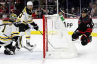 Carolina Hurricanes' Max Domi (13) dives over the net after getting the puck past Boston Bruins' Charlie McAvoy (73) and goaltender Jeremy Swayman (1) for a goal during the second period of Game 7 of an NHL hockey Stanley Cup first-round playoff series in Raleigh, N.C., Saturday, May 14, 2022. (AP Photo/Karl B DeBlaker)