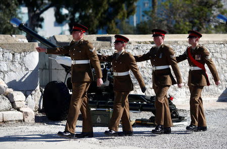 Members of the Royal Gibraltar Regiment march after firing a 21-gun salute to mark the 67th anniversary of Britain's Queen Elizabeth's accession to the throne, in front of the Rock in the British overseas territory of Gibraltar, historically claimed by Spain February 6, 2019. REUTERS/Jon Nazca