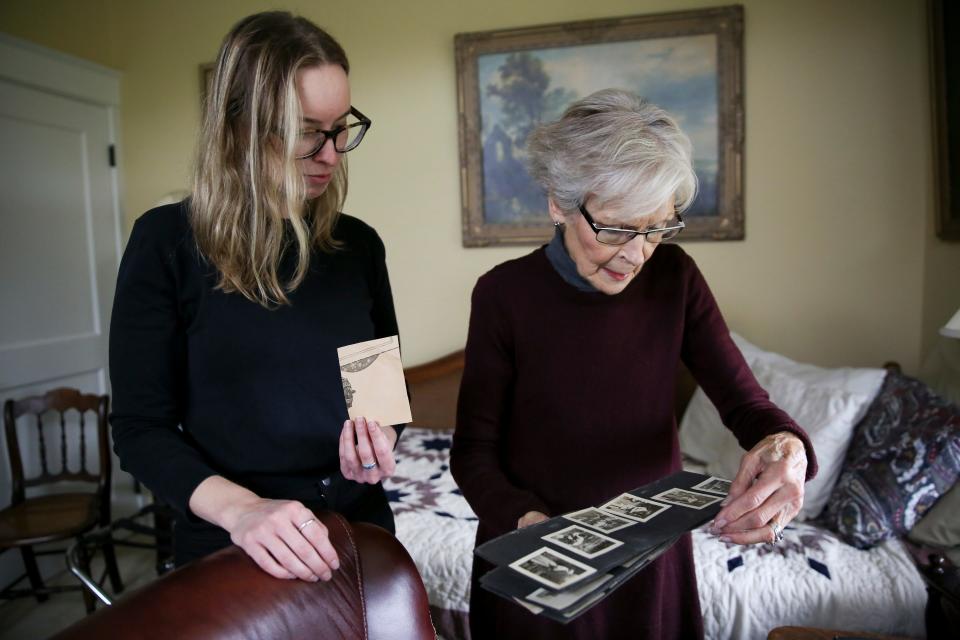 Statesman Journal reporter Claire Withycombe and her grandmother, Kathy Withycombe, look through photographs of their family on Thursday, Nov. 11, 2021, in Hillsboro, Ore.