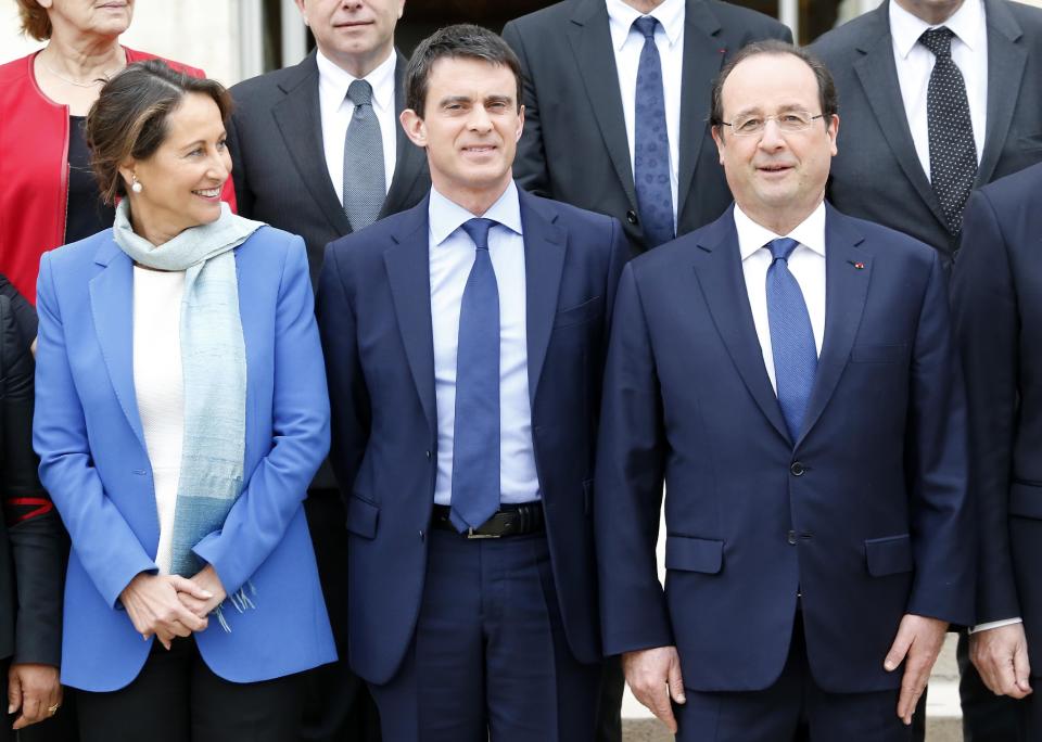 French President Francois Hollande, right, new French Prime Minister Manuel Valls, center, and Environment and Energy minister Segolene Royal pose during the family picture after the first weekly cabinet meeting after municipal elections, at the Elysee Palace in Paris, Friday, April 4, 2014. President Francois Hollande shook up the government this week after his Socialist Party suffered an electoral defeat in nationwide municipal elections. Among two new faces in the Cabinet is Segolene Royal, a longtime politician and mother of Hollande's children, as environment and energy minister. (AP Photo/Jacques Brinon)