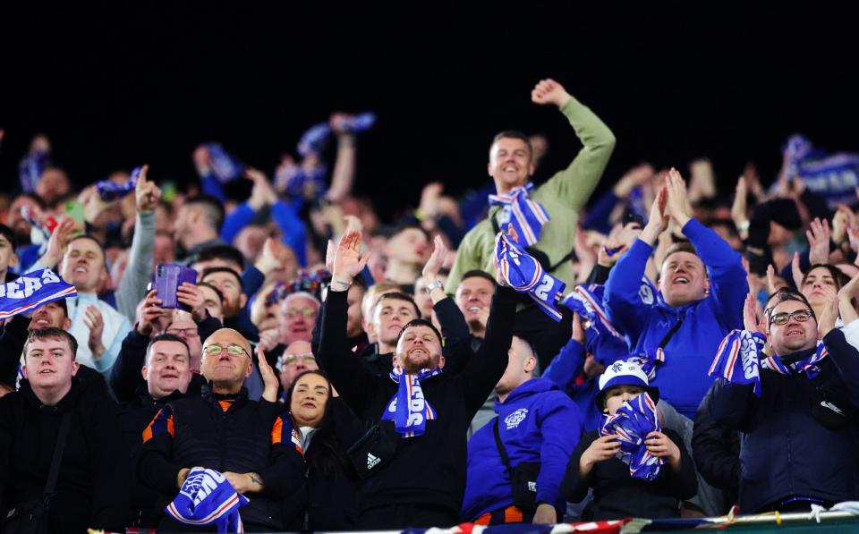 Rangers fans celebrate after the team's victory and qualification to the Round of 16