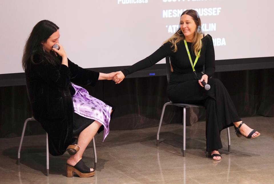 Lily Gladstone, left, holds hands with Erica Tremblay as the credits roll and the film's last song plays at the 2023 deadCenter Film Festival closing-night screening of "Fancy Dance" at the First Americans Museum, Sunday, June 11, 2023.