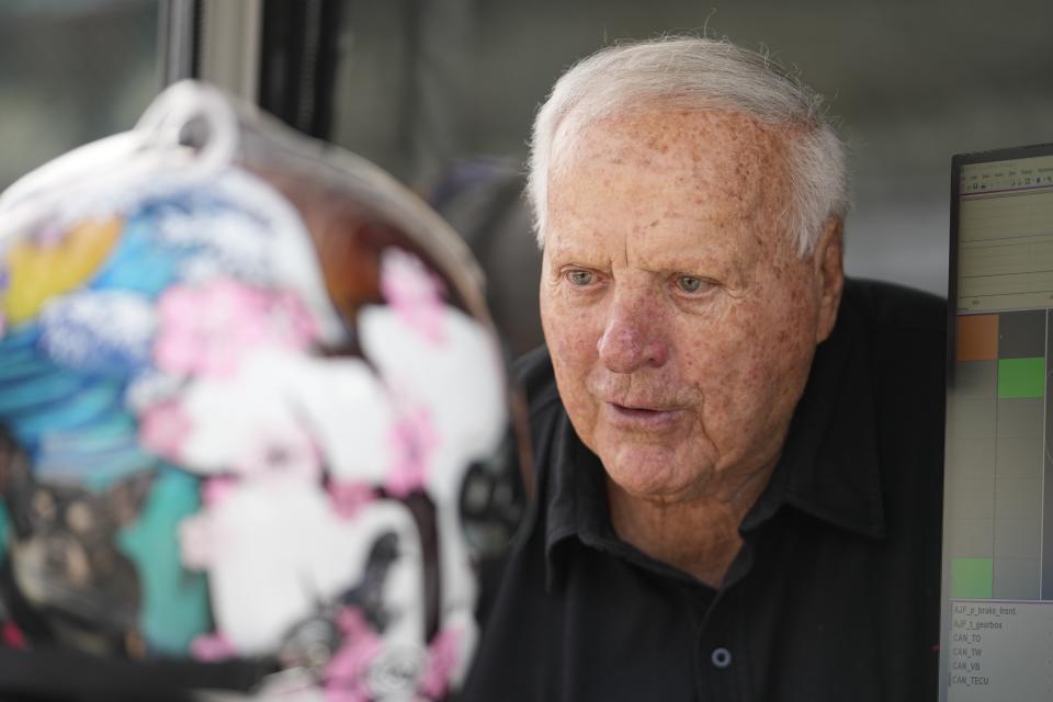 A.J. Foyt talks with Santino Ferrucci during practice for the IndyCar Grand Prix auto race at Indianapolis Motor Speedway, Friday, May 12, 2023, in Indianapolis. (AP Photo/Darron Cummings)