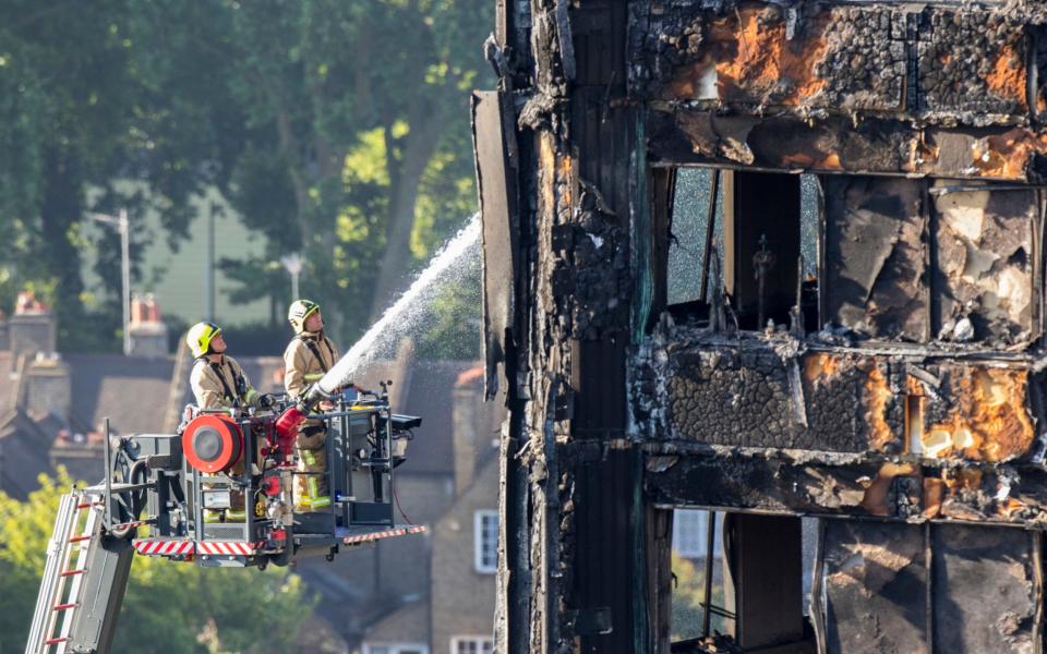 Water is sprayed on Grenfell Tower in west London after a fire engulfed the 24-storey building on Wednesday morning - Credit: Rick Findler/PA 