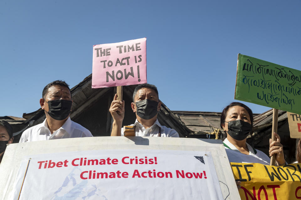 Exile Tibetans participate in a street protest to highlight environmental issues in Tibet ahead of the COP26 summit, in Dharmsala, India, Friday, Oct. 22, 2021. (AP Photo/Ashwini Bhatia)