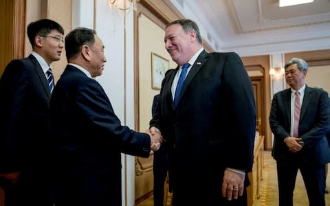 U.S. Secretary of State Mike Pompeo greets North Korean Director of the United Front Department Kim Yong Chol as they arrive for a meeting at the Park Hwa Guest House in Pyongyang - Credit: Reuters