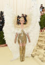 <p>The popstar dominated the red carpet in this gold Cersave minidress, thigh-high gold boots and a pair of massive angel wings. Photo: Getty Images </p>