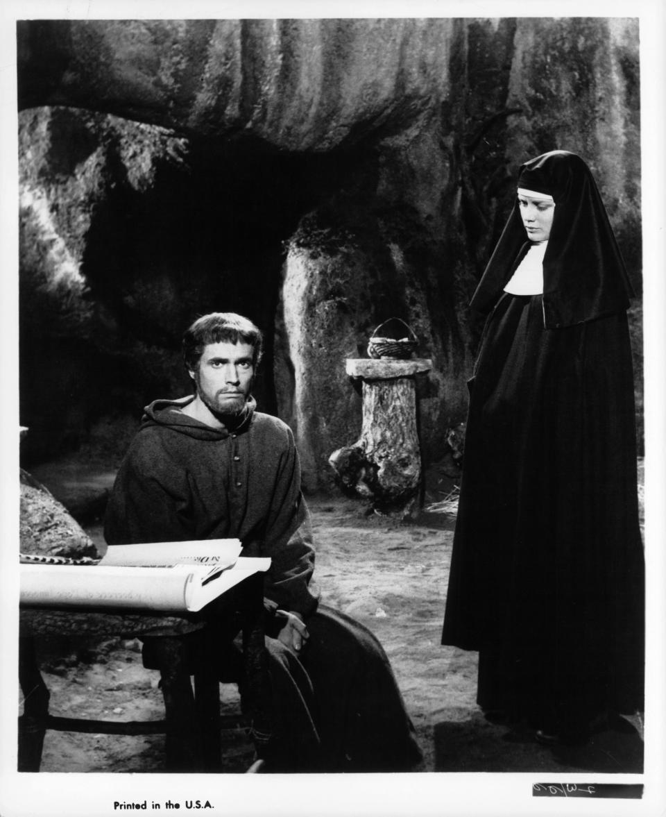 A somber Bradford Dillman sits as nun Dolores Hart looks over him in a scene from the film 'Francis Of Assisi', 1961. (Photo by 20th Century-Fox/Getty Images)