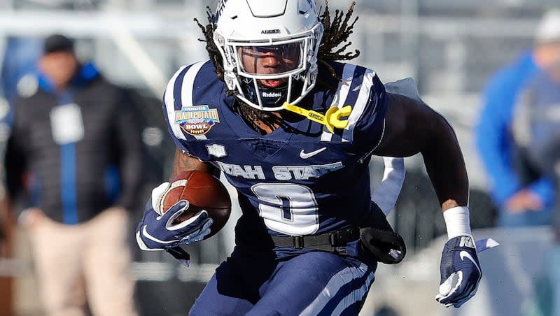 Utah State running back Rahsul Faison (3) runs with the ball against Georgia State in the first half of the Famous Idaho Potato Bowl NCAA college football game, Saturday, Dec. 23, 2023, in Boise, Idaho. Georgia State won 45-22.