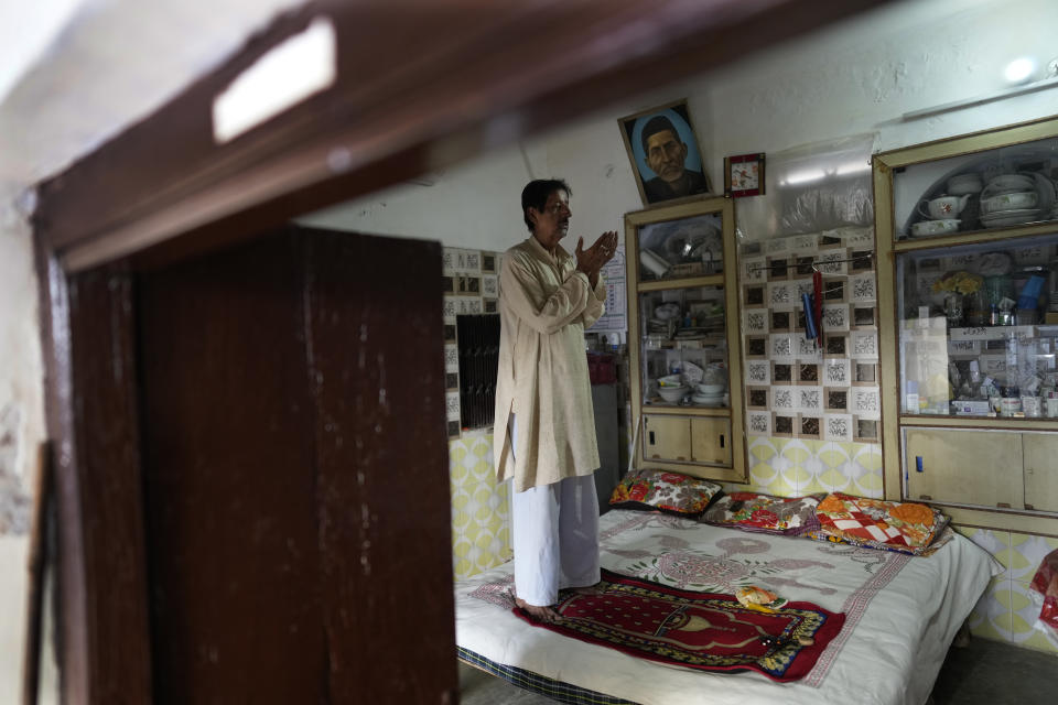 Muslim community leader Syed Mohammad Munir Abidi, 68, prays in his house, in Ayodhya, India, March 28, 2023. Abidi says India is a changed country, one he doesn't recognize anymore. It's a country where Muslims are ignored, where rising attacks against them are encouraged, and where an emboldened Hindu majoritarian government is seizing its chance to put the minority community at its place. (AP Photo/Manish Swarup)