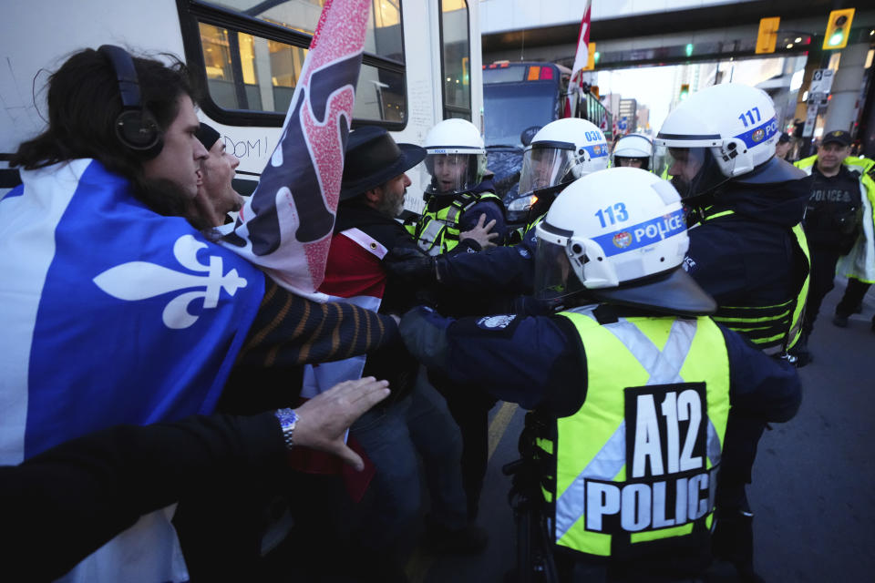 Protesters confront police during a demonstration, part of a convoy-style protest participants are calling "Rolling Thunder," in Ottawa, Ontario, Friday, April 29, 2022. (Sean Kilpatrick/The Canadian Press via AP)