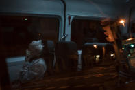 An elderly COVID-19 patient sits inside an ambulance as he waits to be transferred from a Hospital in Barcelona, Spain, March 27, 2020. (AP Photo/Felipe Dana)