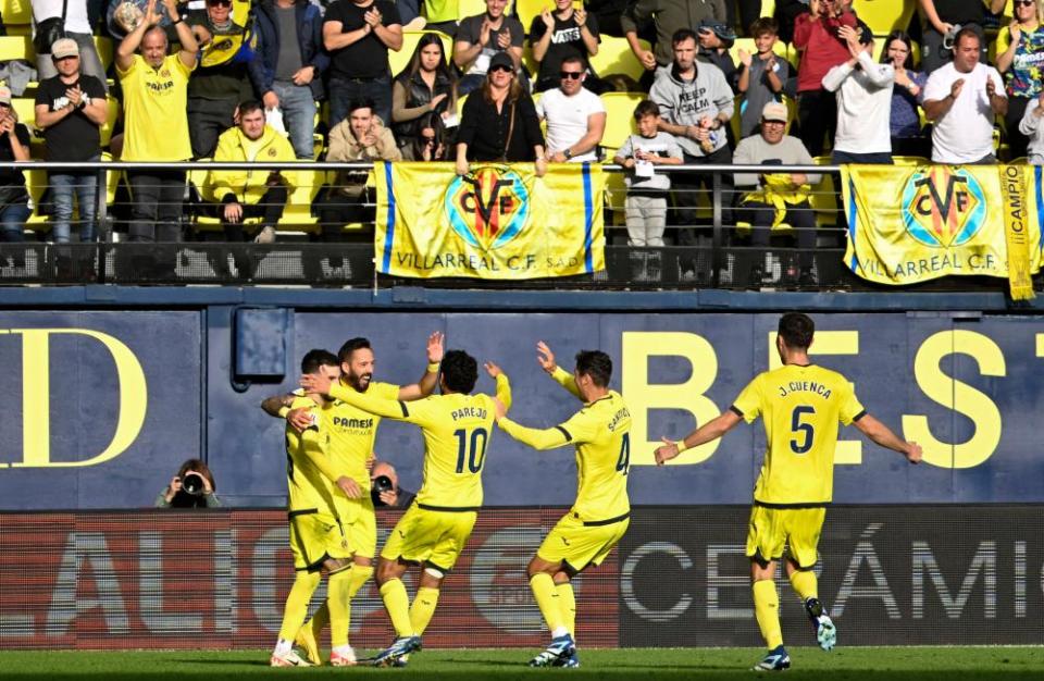 Morales is mobbed by his teammates as the Villarreal faithful stand to applaud