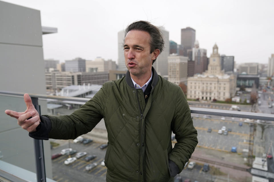 Des Moines Downtown Neighborhood Association president Brandon Brown stands on the roof of his condo building, Friday, Nov. 12, 2021, in Des Moines, Iowa. After decades of downplaying or simply ignoring the problem, Des Moines officials here recently began a comprehensive study that will lead to tighter regulations on some smelly manufacturing plants near downtown. (AP Photo/Charlie Neibergall)