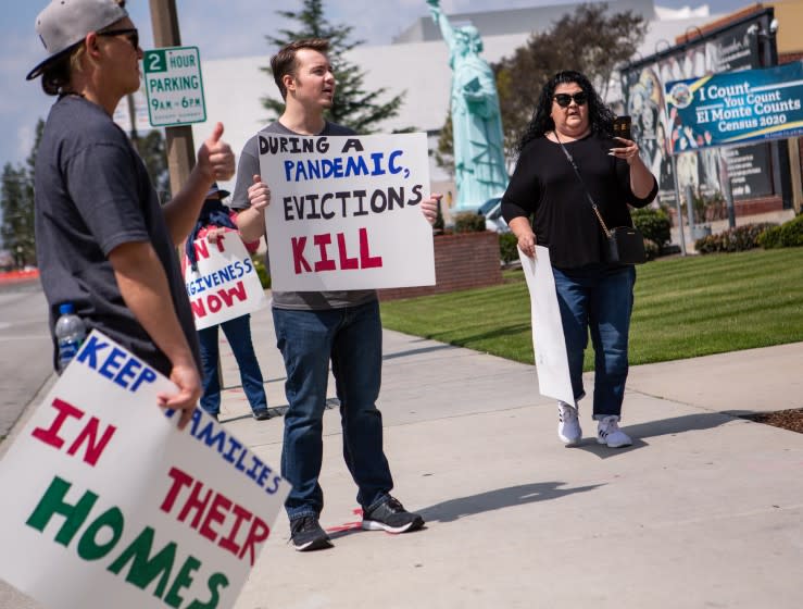 EL MONTE, CA - MARCH 29: Ian Jameson (center) of El Monte organized a group of tenant rights activists and assembled at the El Monte City Hall to demand that the El Monte City Council pass an eviction moratorium barring all evictions during the coronavirus pandemic on Sunday, March 29, 2020 in El Monte, CA. (Jason Armond / Los Angeles Times)