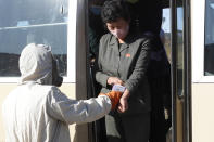 Hygienic and anti-epidemic officials checks the temperature of the people coming to the city of Wonsan, Kangwon Province, North Korea DPRK, on Wednesday, Oct., 28, 2020. (AP Photo/Jon Chol Jin)