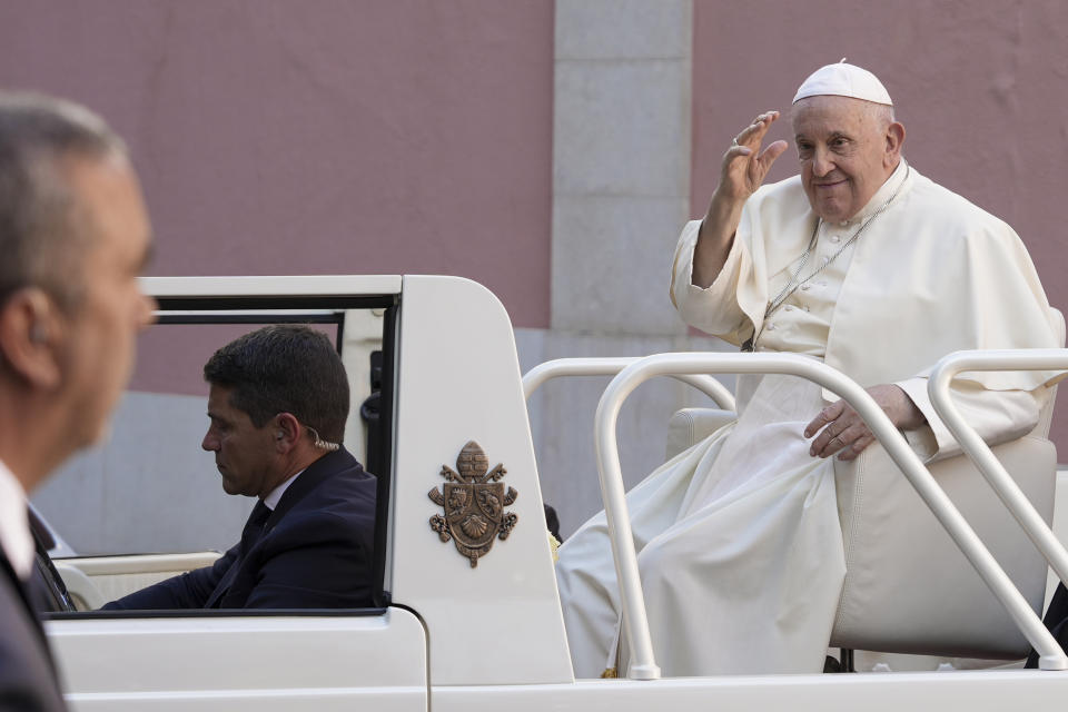 Pope Francis waves as he leaves the nunciature on his way to the "Eduardo VII Park", in Lisbon, to attend a 'Via Crucis' with young people participating into the 37th World Youth Day, Friday, Aug. 4, 2023. Pope Francis is on his third day of a five-day pastoral visit to Portugal that includes the participation at the 37th World Youth Day, and a pilgrimage to the holy shrine of Fatima. (AP Photo/Ana Brigida)