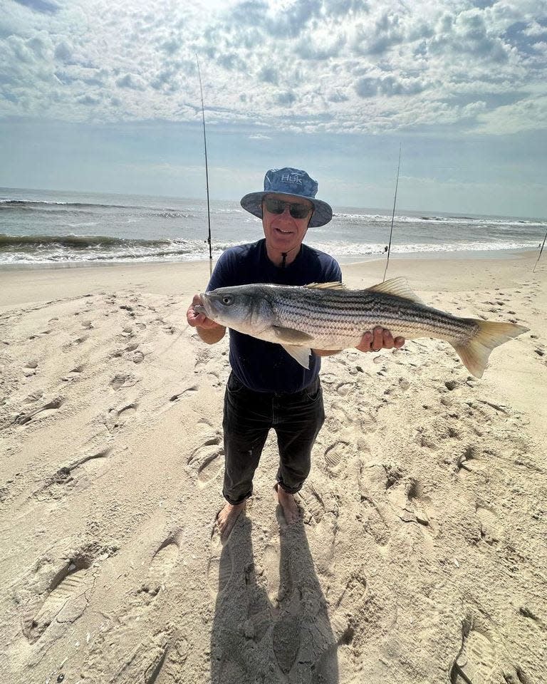 Wayne Kuehler with a 30-inch striped bass off a beach in Ocean County. Kuehler reported the catch to Grumpy's Tackle.