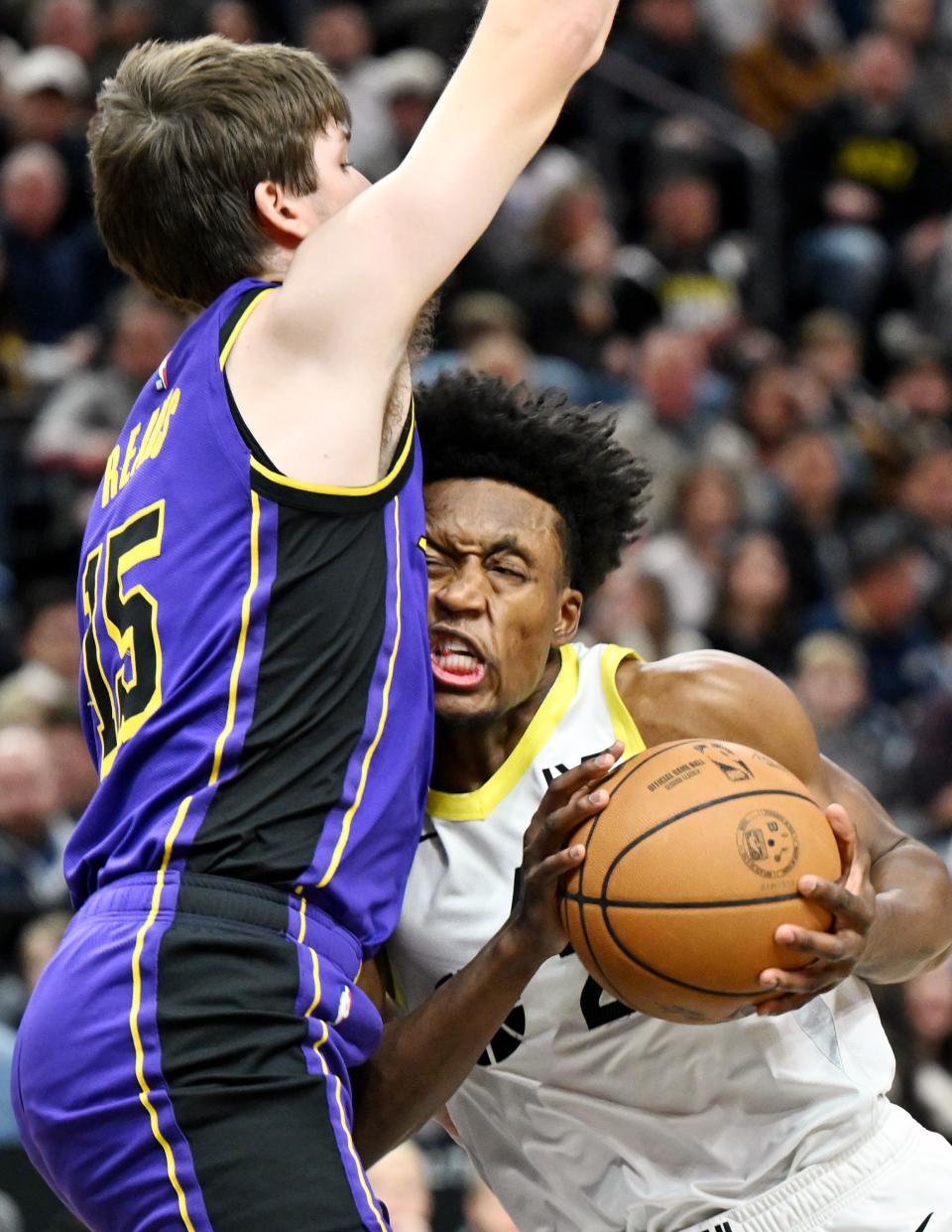 Utah Jazz guard Collin Sexton (2) pushes his face into Los Angeles Lakers guard Austin Reaves (15) as he goes for a shot as Utah and Los Angeles play at the Delta Center in Salt Lake City on Saturday, Jan. 13, 2024. | Scott G Winterton, Deseret News