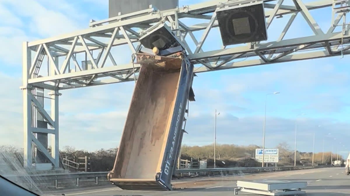 Photo taken with permission from the Twitter feed of Sam Greenslade of the tipper truck which smashed into an overhead gantry on the M5 near Bristol (PA)