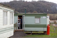 Eastern European workers stand in the doorway of their accommodation at Cobrey Farm in Ross-on-Wye, Britain, March 11, 2019. Picture taken March 11, 2019. REUTERS/Peter Nicholls