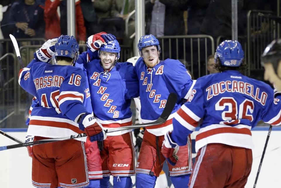 New York Rangers' Benoit Pouliot (67) celebrates with teammates Mats Zuccarello (36), Adam Hall (18) and Derick Brassard (16) after scoring a goal during the second period against the Philadelphia Flyers in Game 7 of an NHL hockey first-round playoff series on Wednesday, April 30, 2014, in New York. (AP Photo)