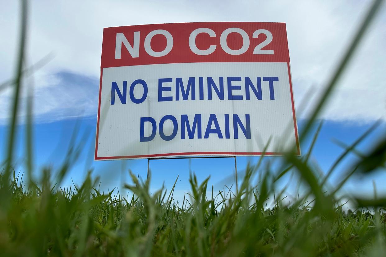 A sign reading "No CO2, no eminent domain" stands along a rural road east of Bismarck, North Dakota, in opposition to Summit Carbon Solutions' proposed $5.5 billion, 2,000-mile pipeline network to carry carbon dioxide emissions from dozens of ethanol plants in five states, including Iowa, to central North Dakota for permanent storage deep underground.