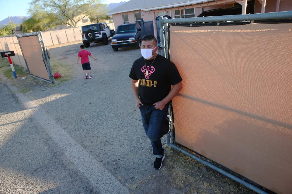 Charlie Aragon, 35, stands outside his home with his son, Charles, 5, in Laveen July 1, 2020. He was hospitalized on a ventilator and close to death after catching COVID-19 in March.