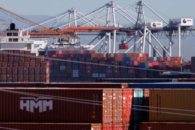 FILE PHOTO: Stacked containers are shown as ships unload their cargo at the Port of Los Angeles