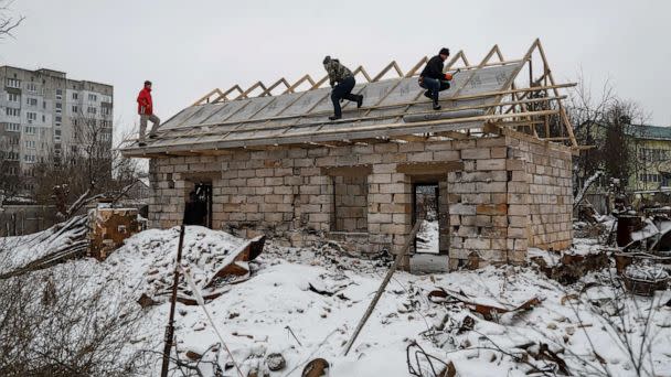 PHOTO: Workers repair a roof of a house heavily damaged in the beginning of Russia's attack on Ukraine, in the town of Borodyanka, Kyiv region, Ukraine, Dec. 15, 2022. (Valentyn Ogirenko/Reuters)