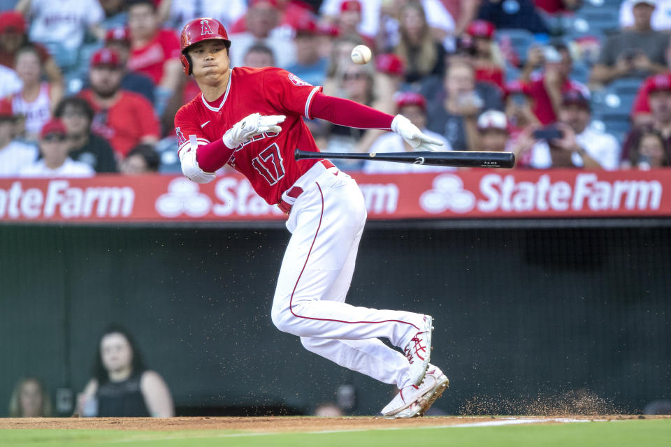 Los Angeles Angels' Shohei Ohtani bunts, but is thrown out at first by Minnesota Twins catcher Gary Sanchez during the first inning of a baseball game in Anaheim, Calif., Saturday, Aug. 13, 2022. (AP Photo/Alex Gallardo)