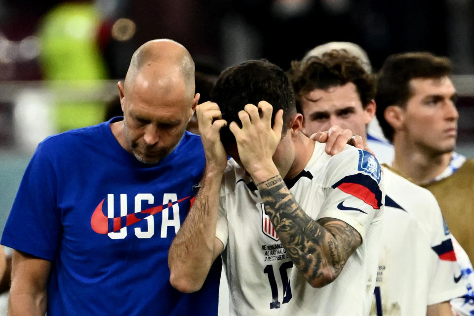 TOPSHOT - USA's coach #00 Gregg Berhalter (L) and USA's forward #10 Christian Pulisic react at the end of the Qatar 2022 World Cup round of 16 football match between the Netherlands and USA at Khalifa International Stadium in Doha on December 3, 2022. (Photo by Jewel SAMAD / AFP) (Photo by JEWEL SAMAD/AFP via Getty Images)