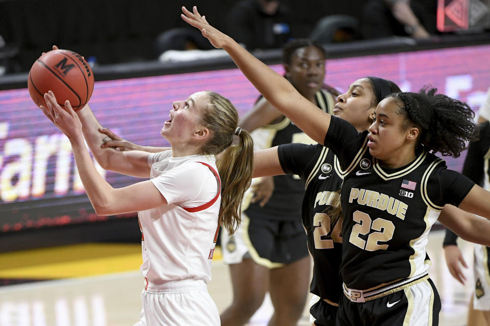 Maryland guard Taisiya Kozlova (14) shoots in front of Purdue guard Jenelle Grant (22) and center Ra Shaya Kyle (24) during the second half of an NCAA college basketball game, Sunday, Jan. 10, 2021, in College Park, Md. (AP Photo/Will Newton)