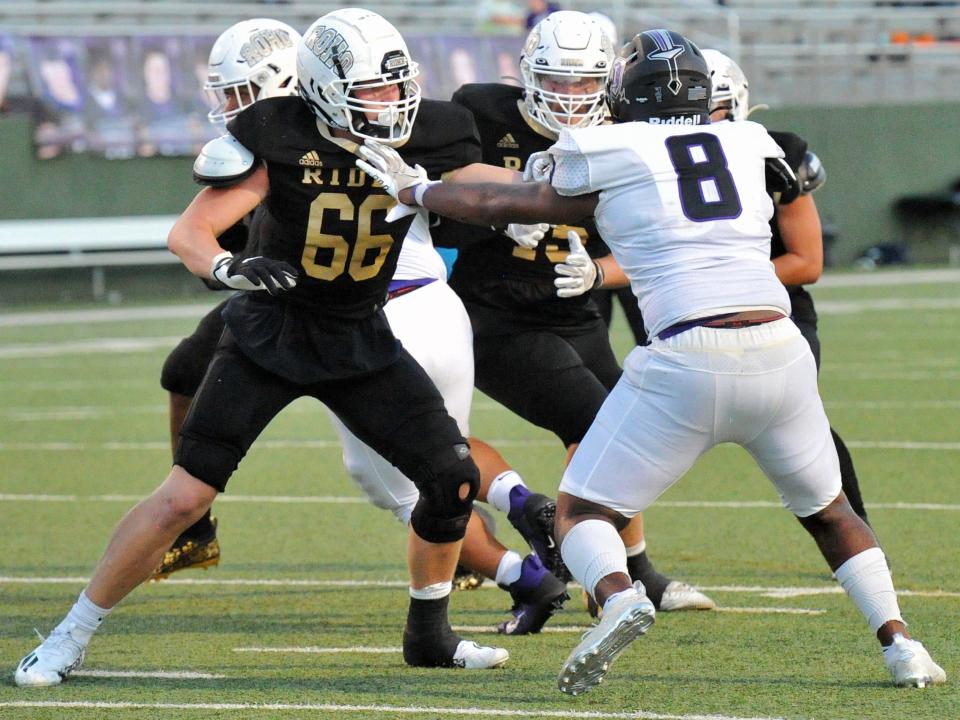 Rider's Norman Mendieta blocks Frisco Independence's Kenny Ayuk on Friday, Sept. 3, 2021, at Memorial Stadium.