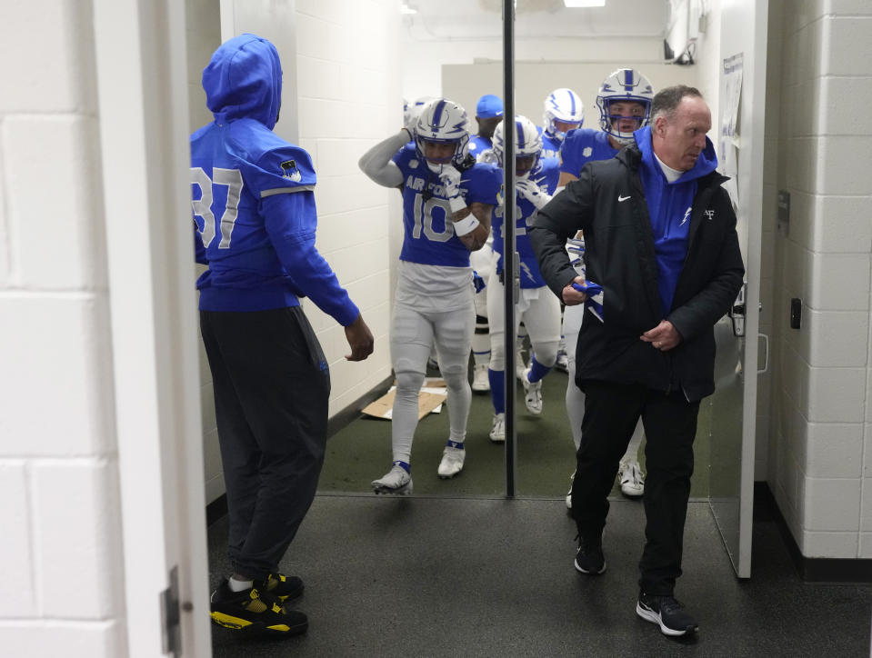 Air Force head coach Troy Calhoun, front right, leads his team out of the visitor's locker room for the first half of an NCAA college football game against Colorado State, Saturday, Oct. 28, 2023, in Fort Collins, Colo. (AP Photo/David Zalubowski)