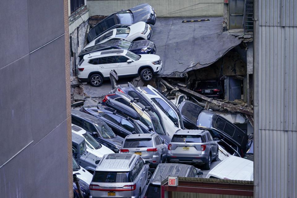 Cars are seen piled on top of each other at the scene of a partial collapse of a parking garage in the Financial District of New York, Tuesday, April 18, 2023, in New York. (AP Photo/Mary Altaffer)