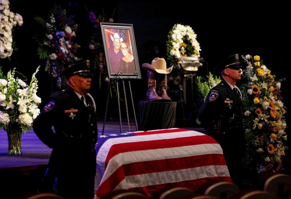 Members of the Arlington Police Department stand beside the coffin of Officer Darrin McMichael during his funeral on Wednesday, September 27, 2023, at Crossroads Christian Church in Grand Prairie. McMichael, a member of Arlington’s Motorcycle Unit, was killed on September 21 while on his way to work.