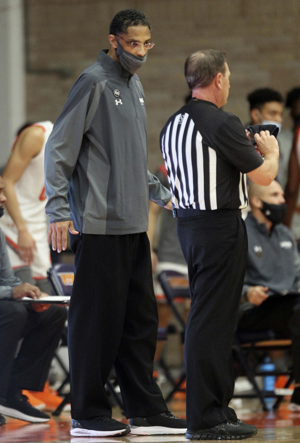 Texas Rio Grande Valley coach Lew Hill talks to an official during an NCAA college basketball game against Dixie State at the UTRGV field house in Edinburg, Texas, Saturday, Jan. 16, 2021. Texas Rio Grande Valley says Hill died Sunday, Feb. 7, 2021, a day after coaching a basketball game against Texas Southern. He was 55. (Delcia Lopez/The Monitor via AP)