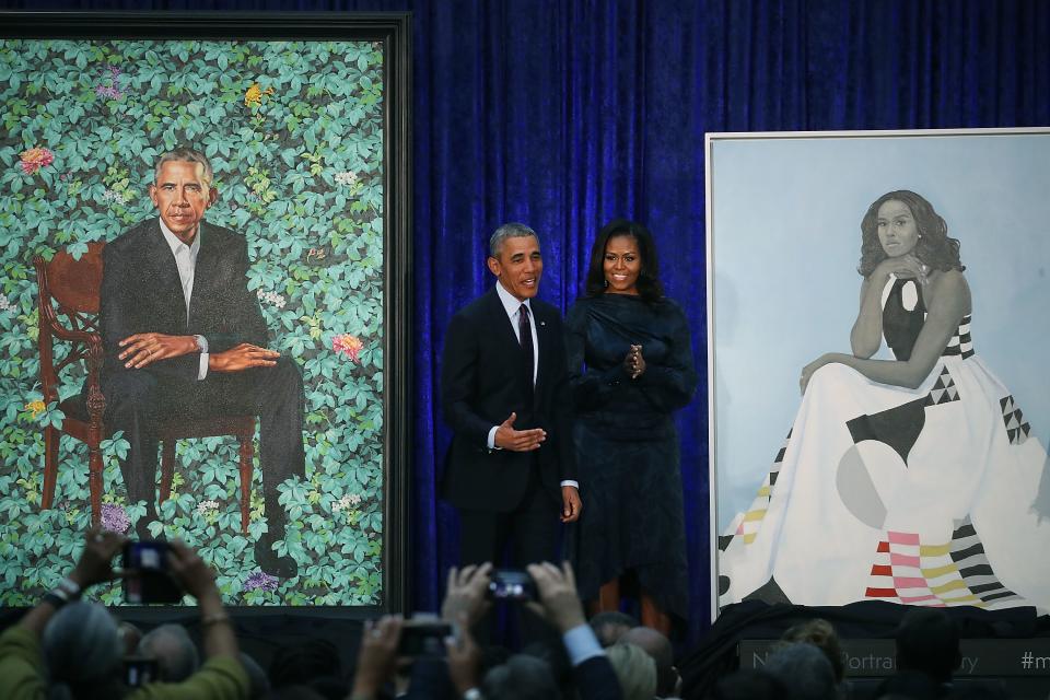 Former U.S. president Barack Obama and former first lady Michelle Obama stand next to their newly unveiled portraits during a ceremony at the Smithsonian's National Portrait Gallery.