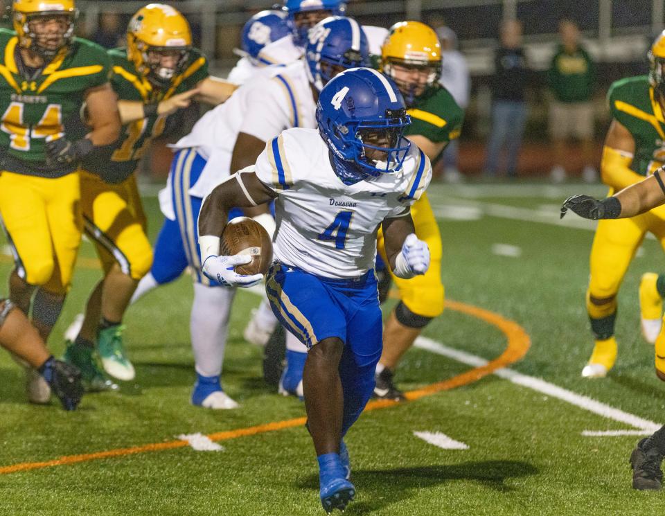 Donovan Catholic's Najee Calhoun looks for running room against the Red Bank Catholic defense Friday night in the Caseys' 14-7 win.