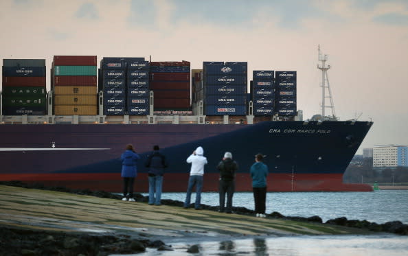 SOUTHAMPTON, ENGLAND - DECEMBER 10: People watch from the jetty at Hythe Marina as The Marco Polo, the world's biggest container ship, leaves Southampton docks on December 10, 2012 in England. On its first visit to Europe, the 54m (177ft) wide and 396m (1299ft) long container ship - which is 51m (167ft) longer than the Queen Mary II - will mostly carry consumer goods for delivery to shops for Christmas. (Photo by Peter Macdiarmid/Getty Images)