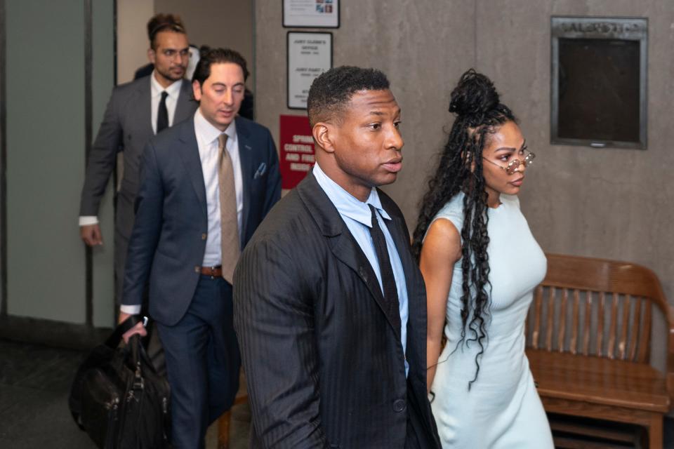 Jonathan Majors (center left), accompanied by girlfriend Meagan Good (center right), enters a courtroom at the Manhattan Criminal Courthouse in New York on Dec. 14, 2023.