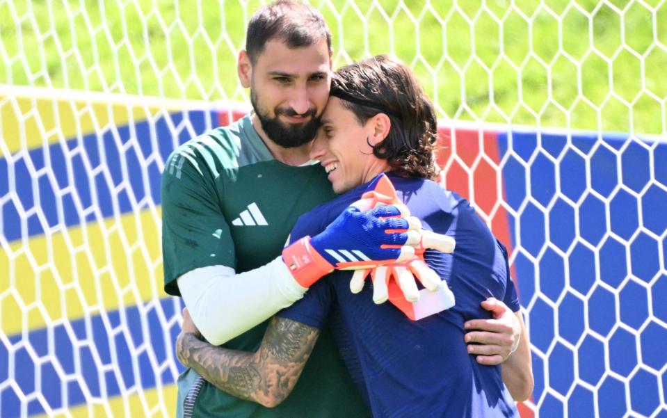 Gianluigi Donnarumma embraces Riccardo Calafiori