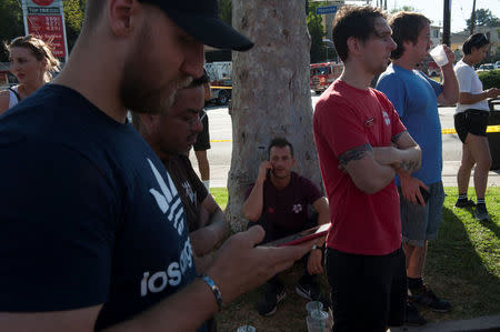 Trader Joe's employees and others wait in a parking lot near a Trader Joe's store where a hostage situation unfolded in Los Angeles, California, Saturday July 21, 2018. REUTERS/Andrew Cullen