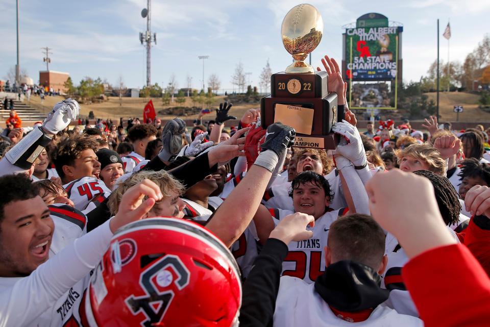 The Carl Albert team celebrates following a 49-7 win against McAlester in the Class 5A state football championship game on Dec. 3 at Chad Richison Stadium in Edmond.