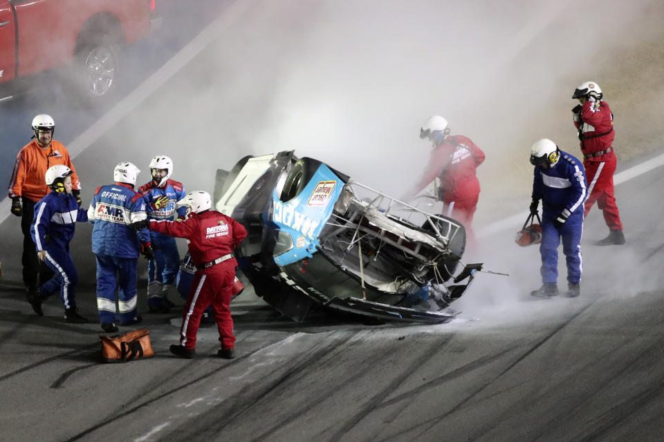 Rescue workers arrive to check on Ryan Newman after he was involved in a wreck on the last lap of the NASCAR Daytona 500 auto race at Daytona International Speedway, Monday, Feb. 17, 2020, in Daytona Beach, Fla. Sunday's race was postponed because of rain. (AP Photo/David Graham)